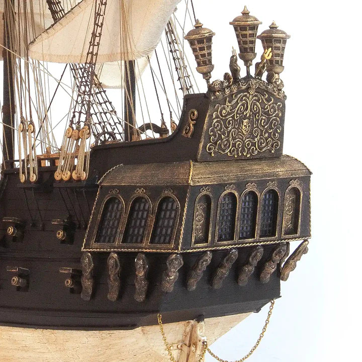 Detailed view of the OcCre Black Swan 12012 wooden pirate ship model featuring ornate stern galleries, decorative windows and wooden architectural details.