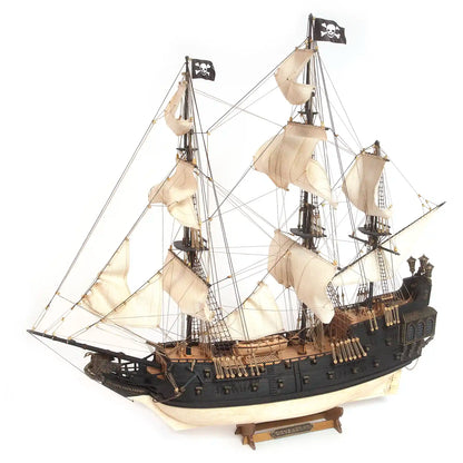 OcCre The Black Swan wooden pirate ship model kit, 1:75 scale (12012), showing the completed sailing vessel with black hull, decorative stern, sails and rigging.