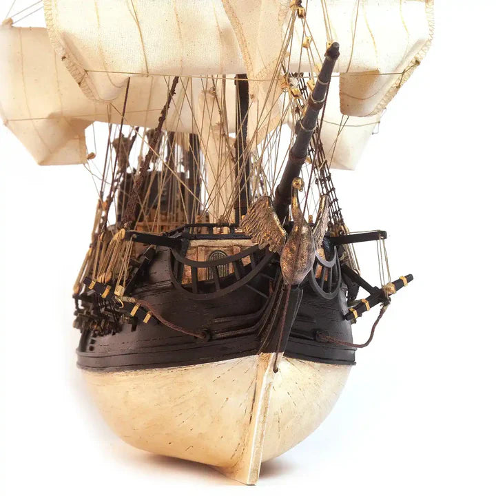 Rear view of the completed OcCre Black Swan 12012 wooden pirate ship model showing its decorated stern, sailing rig and detailed wooden structures.