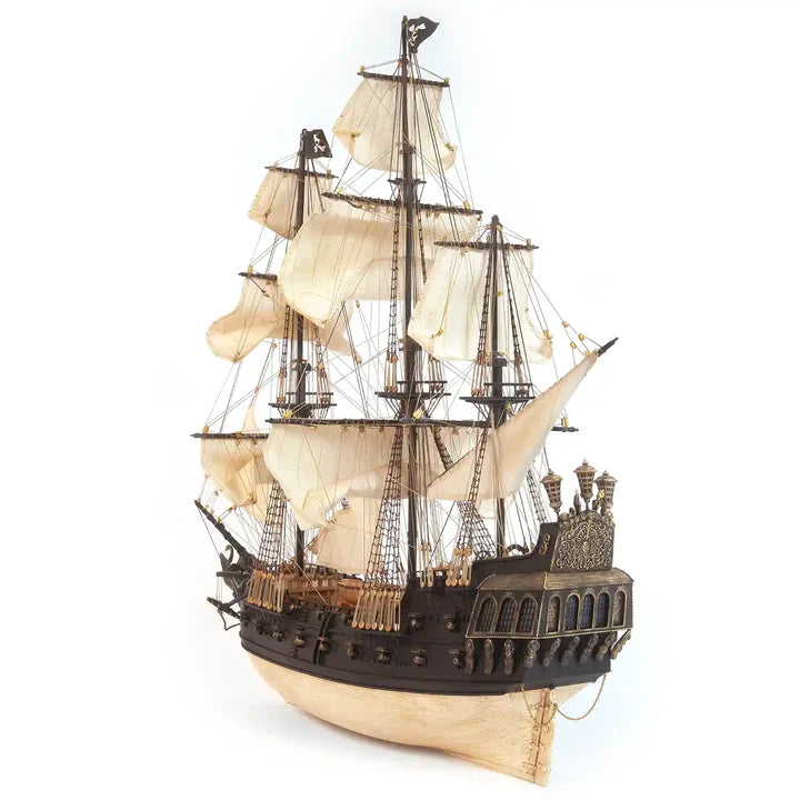 Three-quarter view of the completed OcCre Black Swan 12012 wooden pirate ship model featuring multiple masts, detailed sails and dark wooden hull.