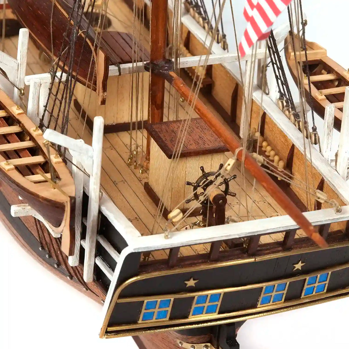 Detailed stern view of the OcCre Essex 12006 wooden ship model featuring decorative stern windows, wooden deck structures, railings and nautical fittings.