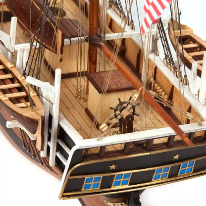 Detailed stern view of the OcCre Essex 12006 wooden ship model featuring decorative stern windows, wooden deck structures, railings and nautical fittings.
