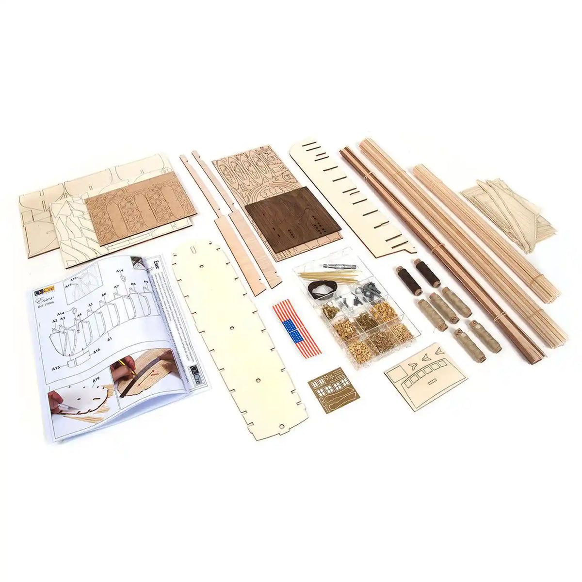 OcCre Essex 12006 wooden whaling ship model kit components showing wooden construction parts, model fittings, printed materials and assembly pieces.