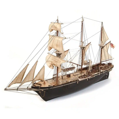 Three-quarter view of the completed OcCre HMS Endurance 12008 wooden ship model featuring detailed black hull, wooden decks, three masts, sails, and rigging.
