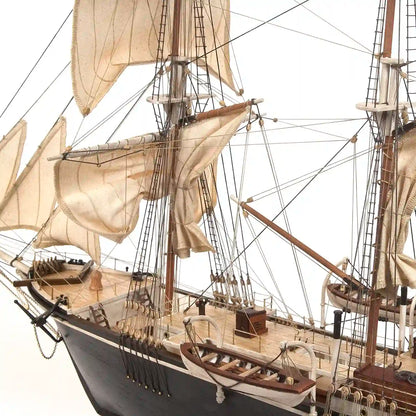 Close-up of the completed OcCre HMS Endurance wooden model ship showing the stern section, deck fittings, lifeboats, masts, and rigging.